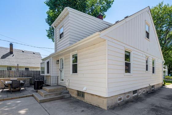 Rear exterior showing the back entry, patio seating and off-street parking